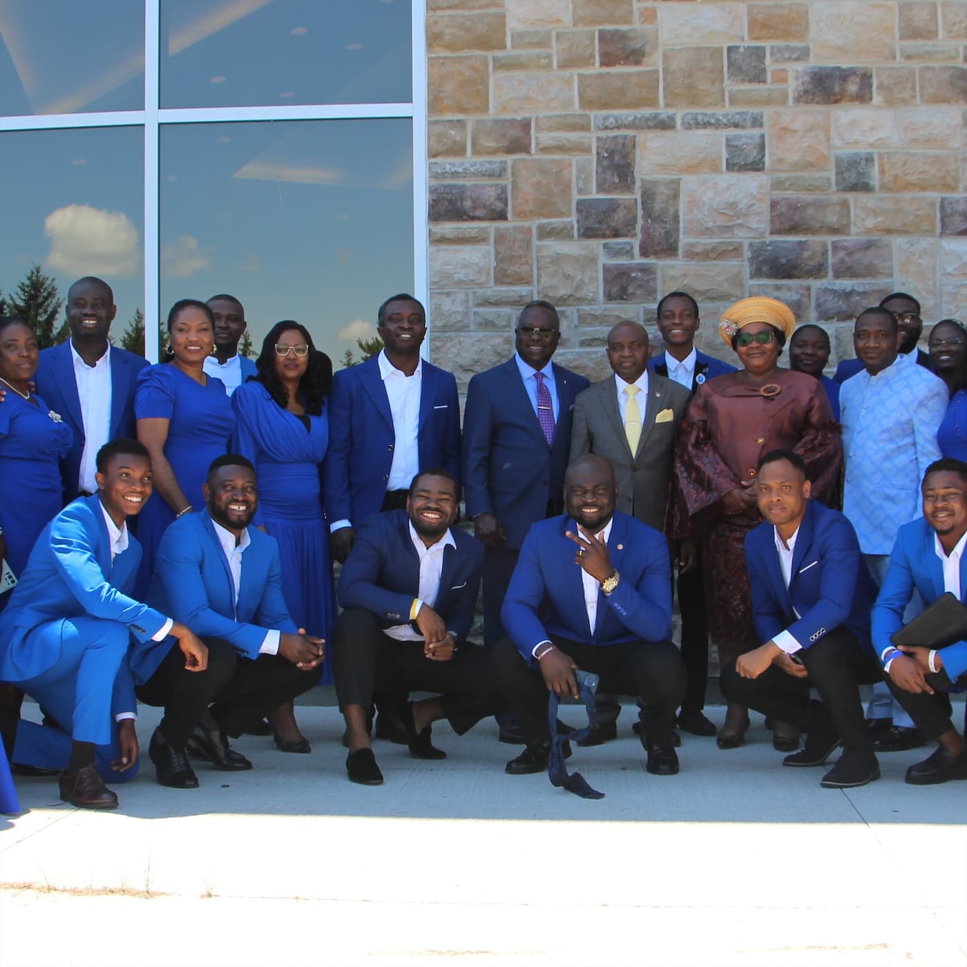 The choir gathered outside the church in blue